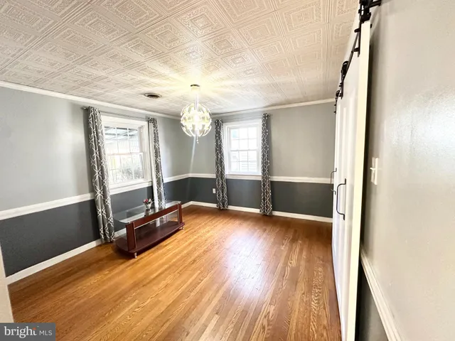 a view of a room with wooden floor and windows