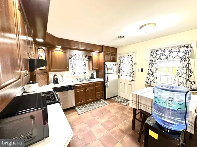 a kitchen with stainless steel appliances kitchen island granite countertop a sink stove and granite counter top