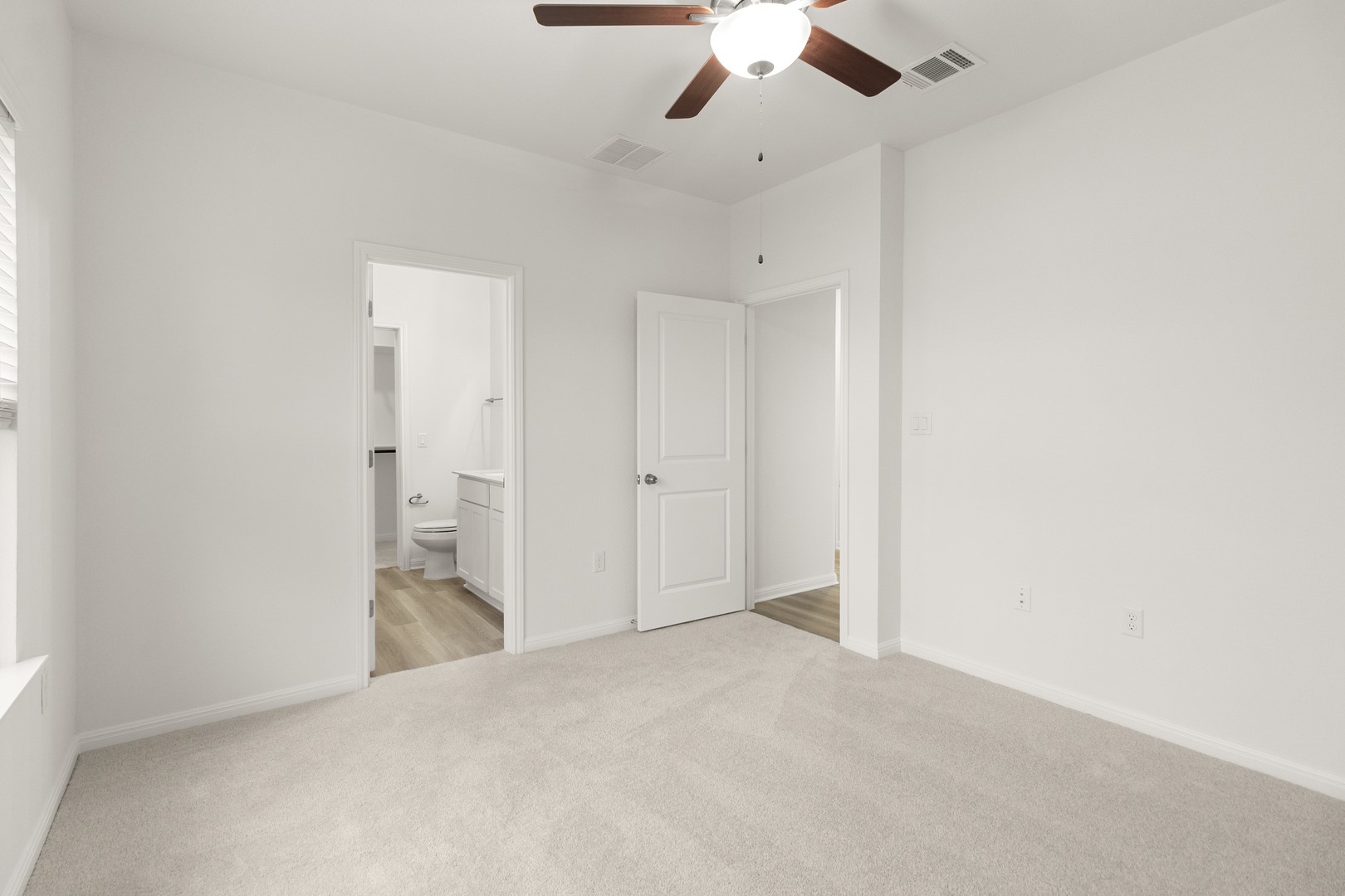 18605 Emu Lane Manor, TX 78653 - Photo 20 of 27 Bright room featuring light-colored carpeting, white walls, and a ceiling fan with a light fixture
