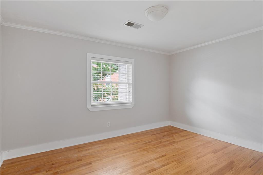 866 Briarcliff Road Northeast, Unit B3 Atlanta, GA 30306 - Photo 14 of 17 an empty room with wooden floor and windows