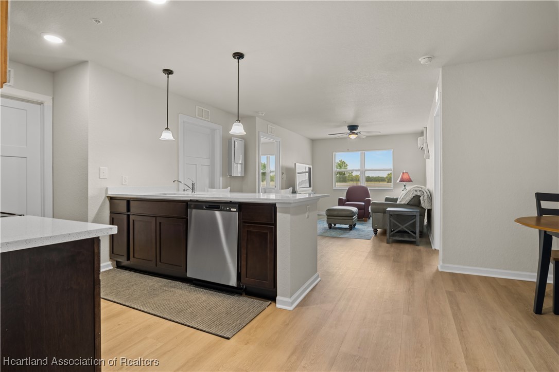260 Spanish Moss Circle, Unit 101 Sebring, FL 33876 - Photo 2 of 35 a kitchen with stainless steel appliances granite countertop a sink a stove and a wooden floors