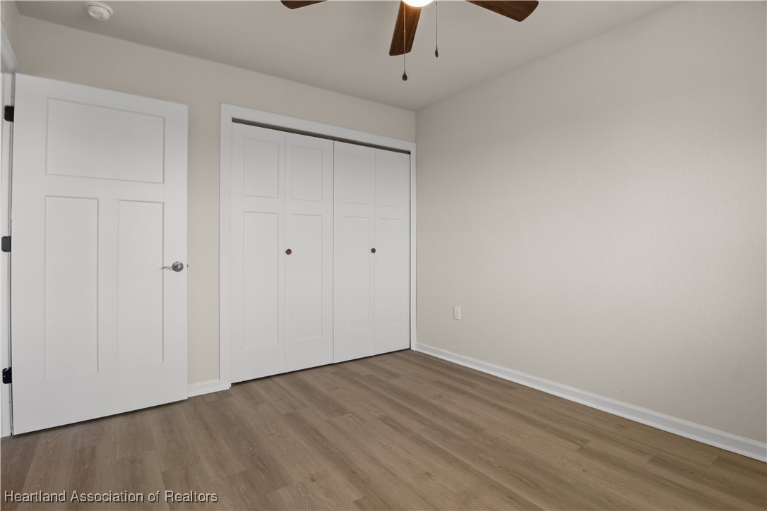 260 Spanish Moss Circle, Unit 101 Sebring, FL 33876 - Photo 7 of 35 a view of an empty room with wooden floor
