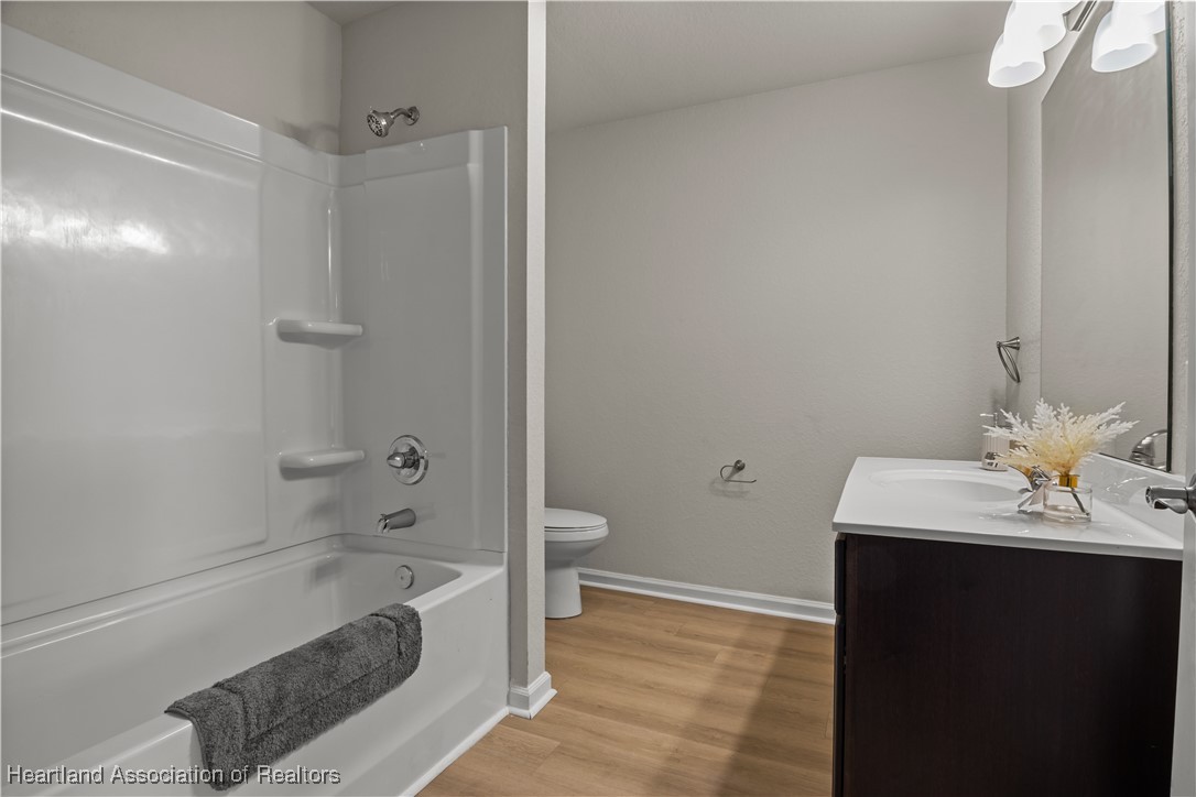 260 Spanish Moss Circle, Unit 101 Sebring, FL 33876 - Photo 8 of 35 a bathroom with a sink a toilet and shower