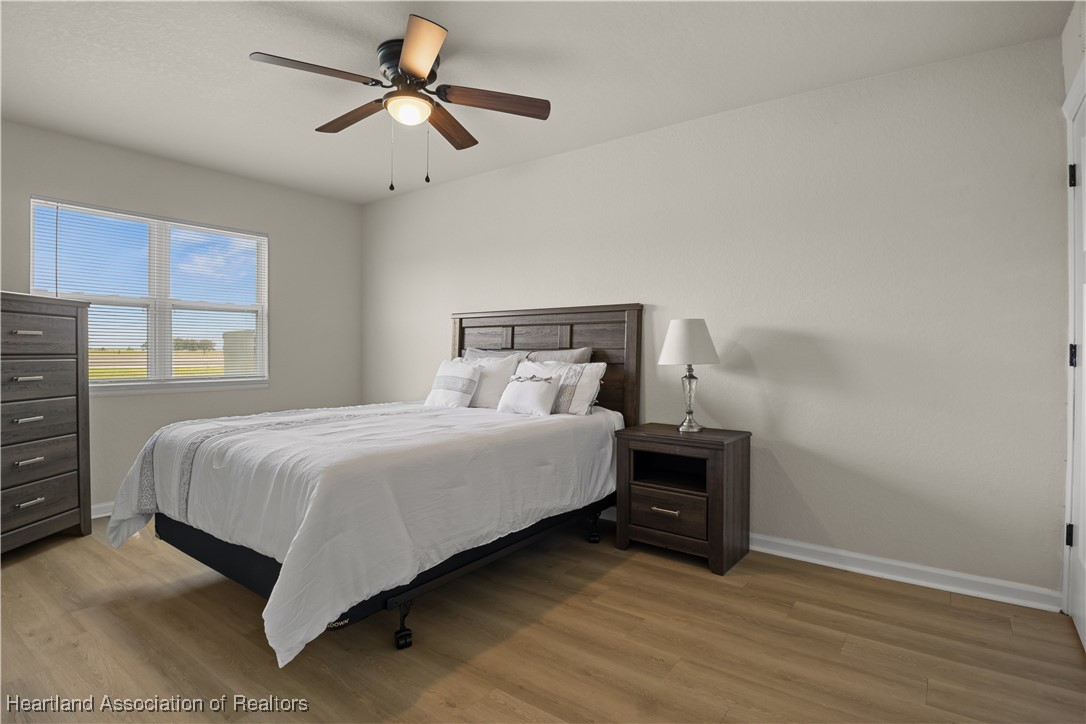260 Spanish Moss Circle, Unit 101 Sebring, FL 33876 - Photo 9 of 35 a bedroom with a bed and a ceiling fan