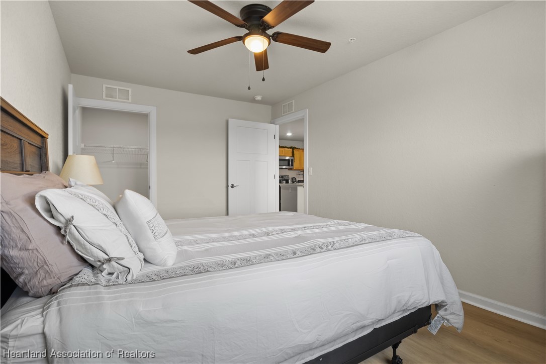 260 Spanish Moss Circle, Unit 101 Sebring, FL 33876 - Photo 10 of 35 a bedroom with a bed and a chandelier