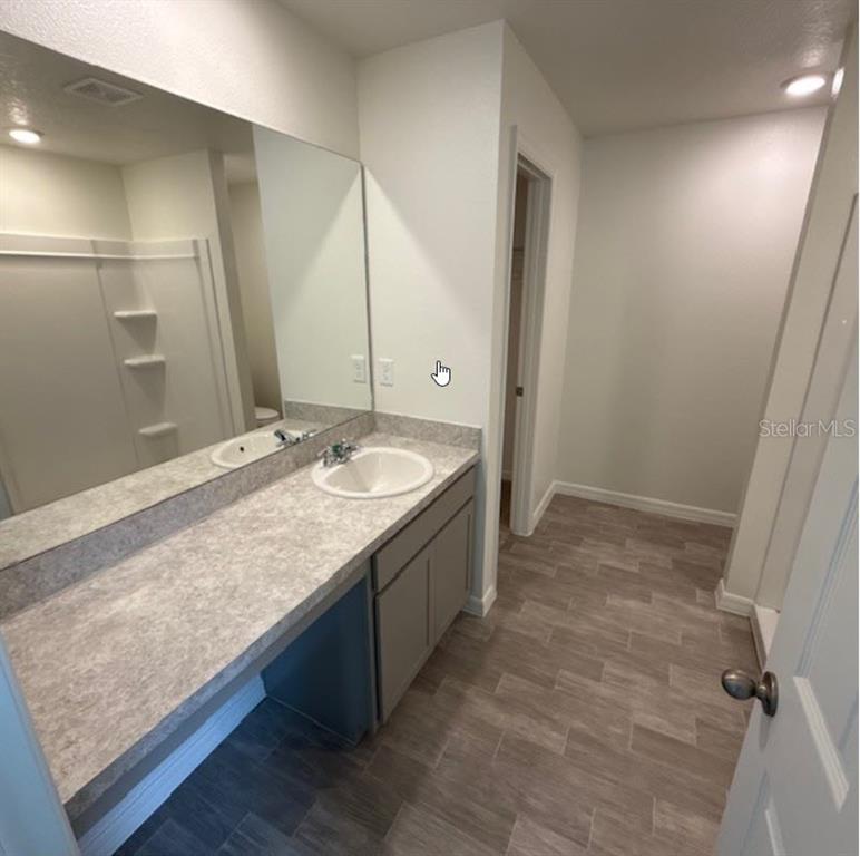 31 Pine Cedar Drive Palm Coast, FL 32164 - Photo 12 of 15 a spacious bathroom with a granite countertop sink and a mirror