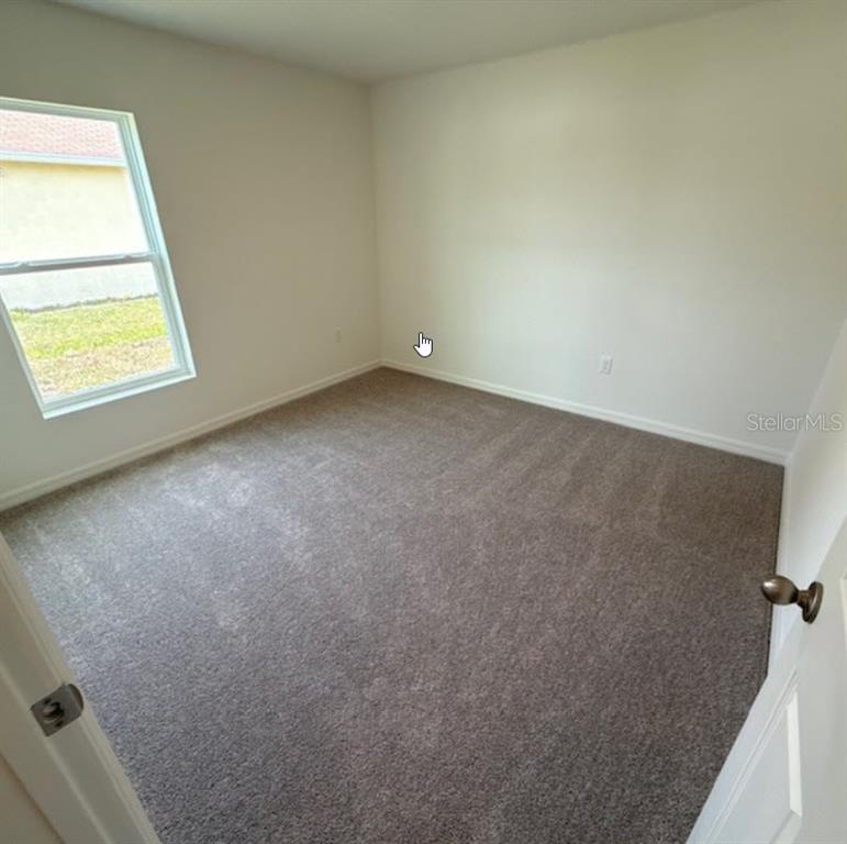 31 Pine Cedar Drive Palm Coast, FL 32164 - Photo 6 of 15 an empty room with windows