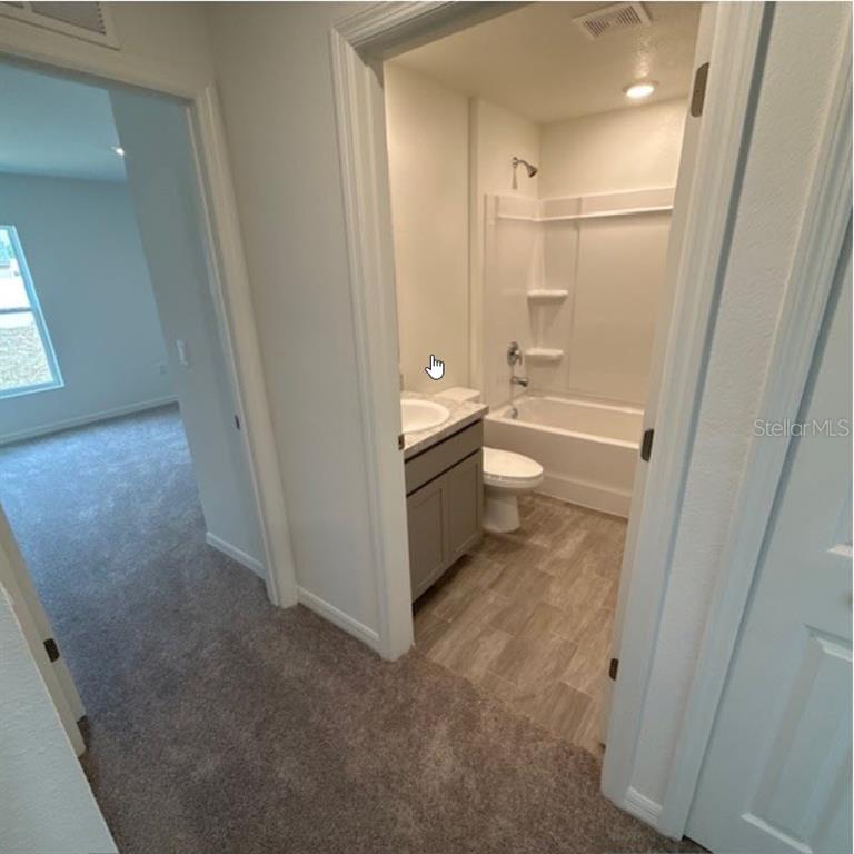 31 Pine Cedar Drive Palm Coast, FL 32164 - Photo 8 of 15 a bathroom with a granite countertop sink toilet and shower