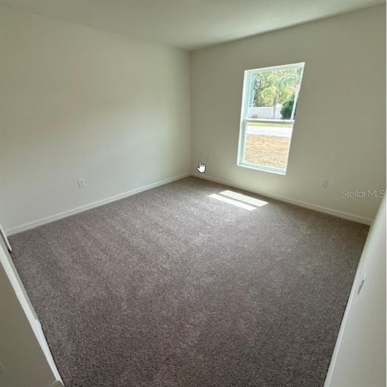 31 Pine Cedar Drive Palm Coast, FL 32164 - Photo 9 of 15 an empty room with windows