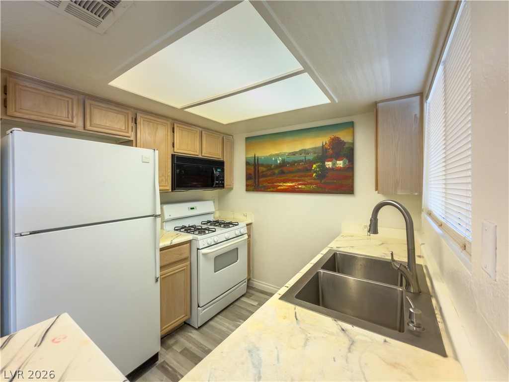 8070 West Russell Road, Unit 2063 Las Vegas, NV 89113 - Photo 4 of 9 A compact kitchen with sleek appliances and practical laminate flooring.