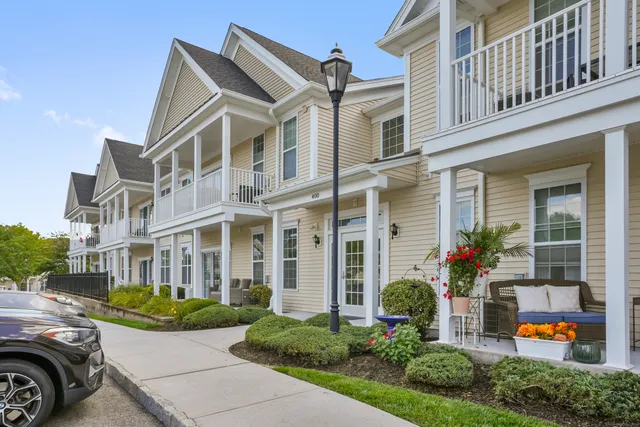 front view of a brick house with a yard