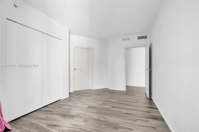 a view of a room with wooden floor