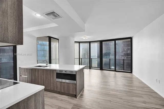 a view of a kitchen with a sink and cabinets