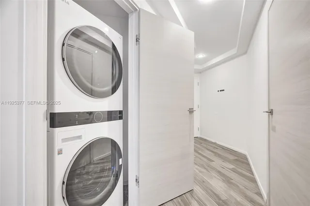 a view of a hallway with washer and dryer