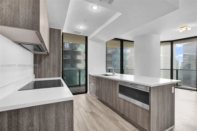 a kitchen with granite countertop a sink and a refrigerator