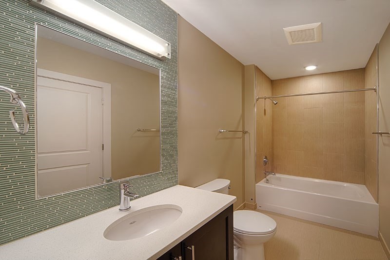 33 Rogers Street, Unit 421 Cambridge, MA 02142 - Photo 5 of 7 a bathroom with a sink a toilet and shower