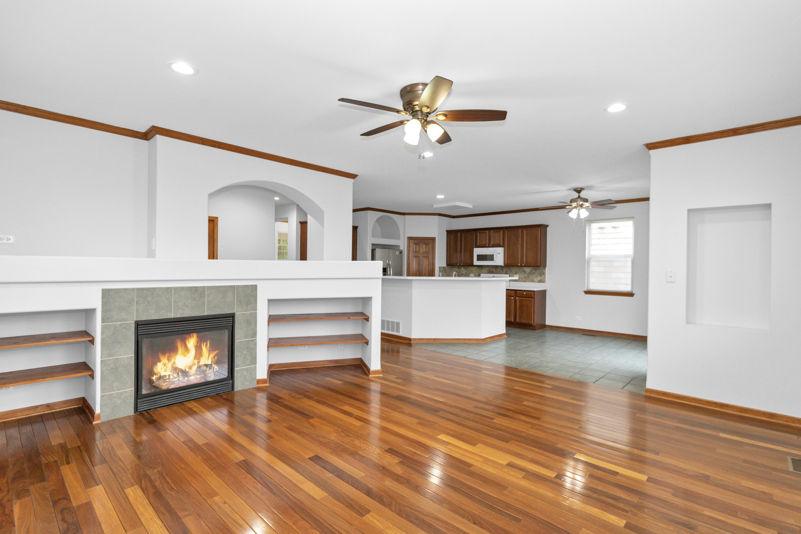 3311 Lafayette Street Elgin, IL 60124 - Photo 14 of 50 a view of a livingroom with a fireplace a ceiling fan and kitchen view