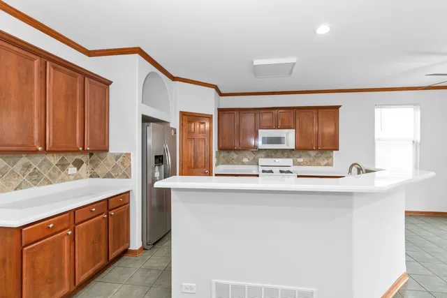 a kitchen with stainless steel appliances a sink and cabinets
