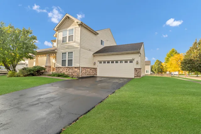 a front view of a house with a yard and garage