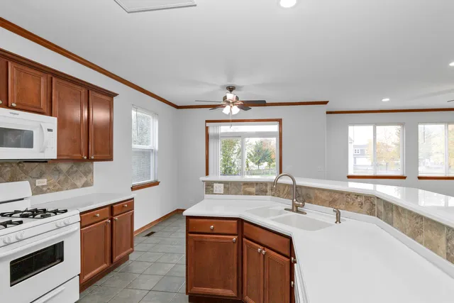 a kitchen with stainless steel appliances granite countertop a sink stove and cabinets