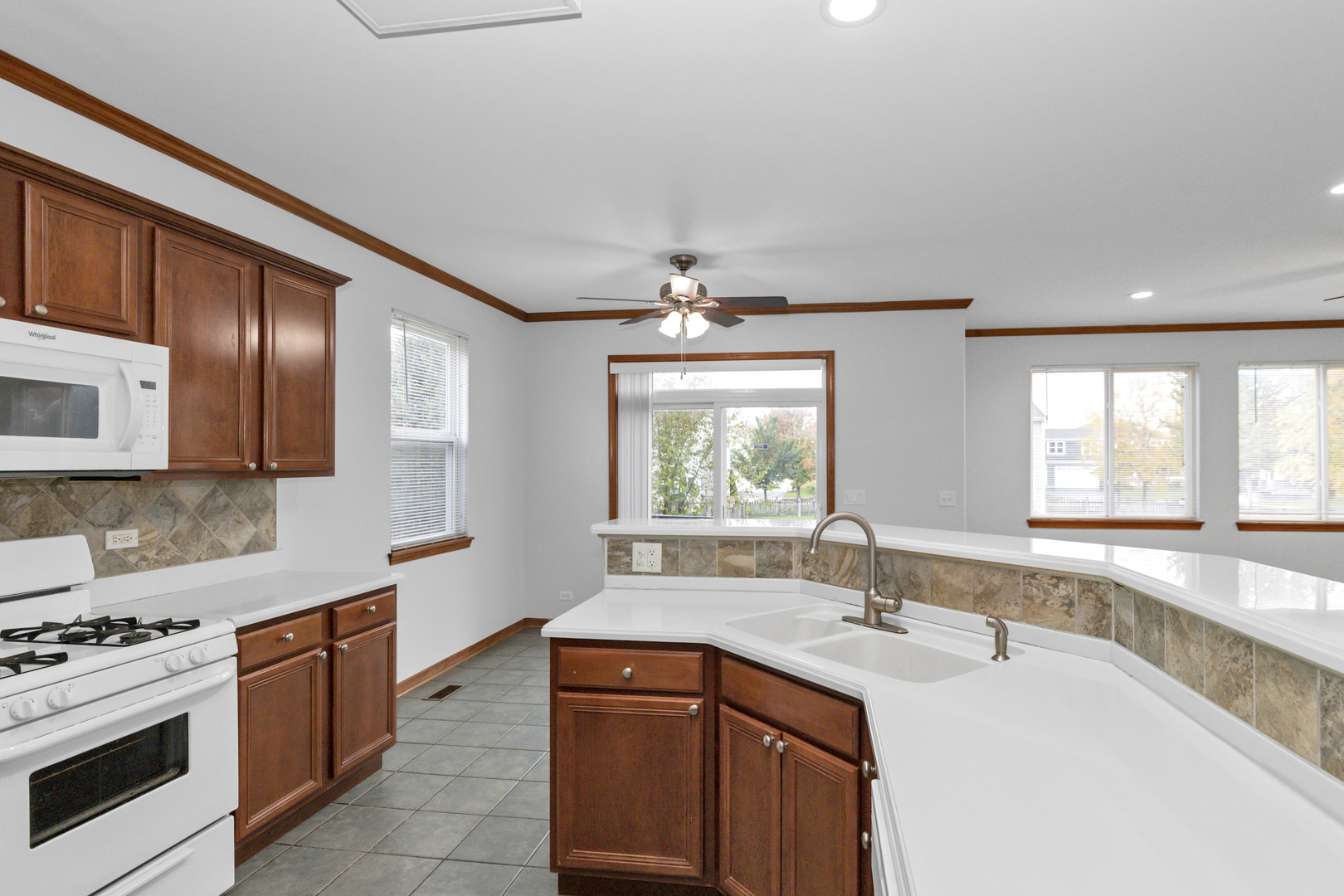 3311 Lafayette Street Elgin, IL 60124 - Photo 21 of 50 a kitchen with stainless steel appliances granite countertop a sink stove and cabinets