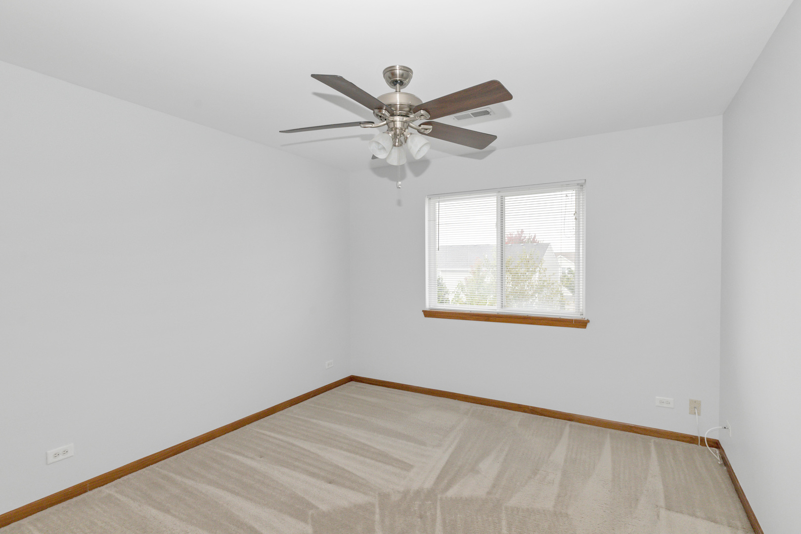 3311 Lafayette Street Elgin, IL 60124 - Photo 31 of 50 an empty room with a window and a ceiling fan