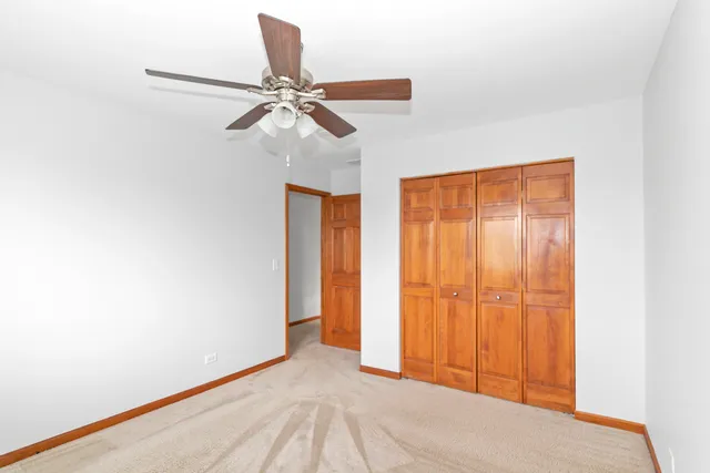 a view of a room with a window and ceiling fan
