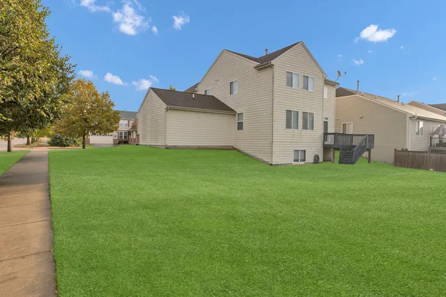 a view of a house with a yard and garage