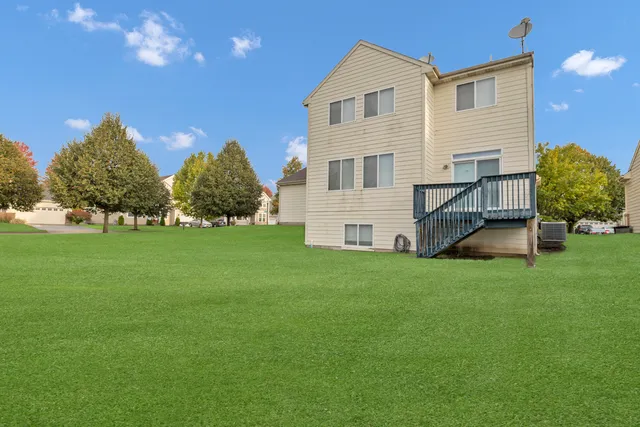 a view of house with backyard