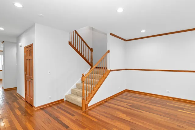 a view of entryway and hall with wooden floor