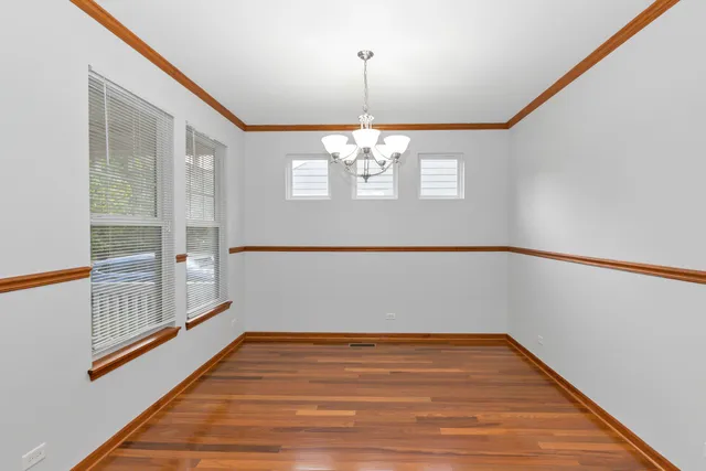 a view of a room with wooden floor and white walls