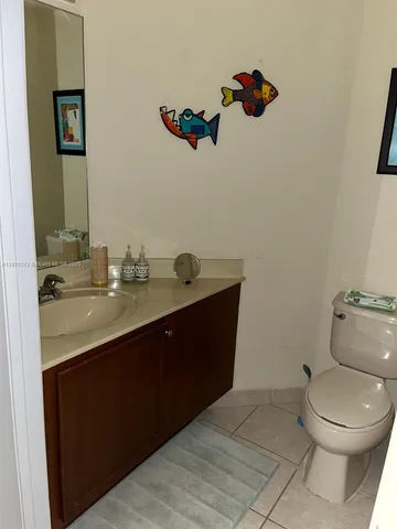 a bathroom with a sink mirror and toilet
