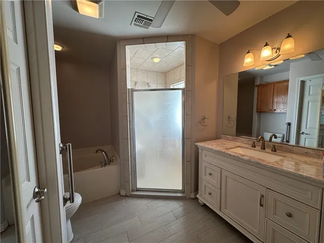 a bathroom with a granite countertop sink mirror and shower