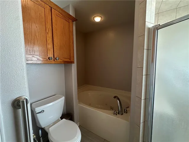 a bathroom with a toilet a sink and bathtub