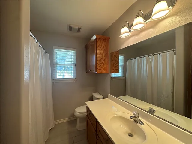 a bathroom with a sink double vanity granite and a mirror
