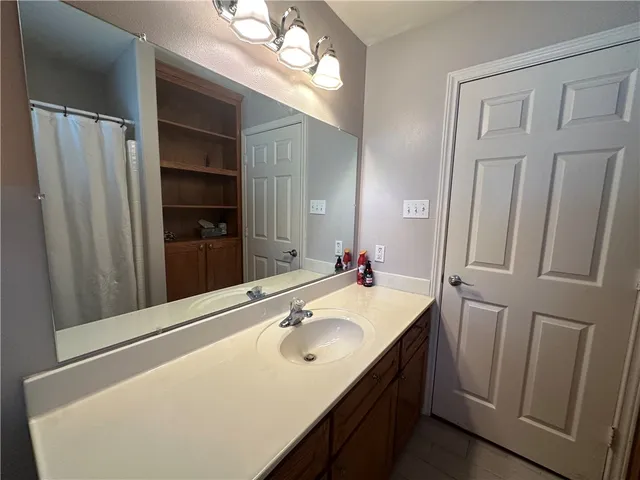 a bathroom with a sink vanity and a mirror