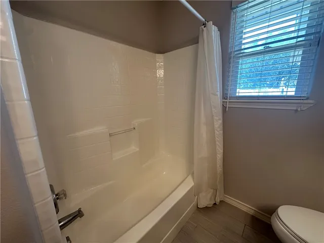 a bathroom with a bathtub and toilet