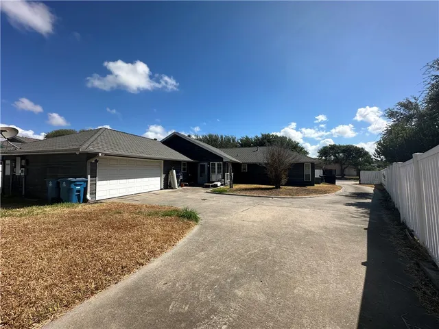 a front view of a house with a yard and a garage