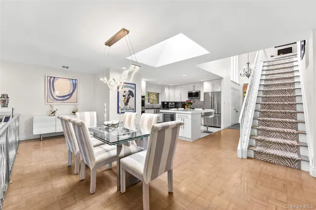 a dining room with furniture and wooden floor