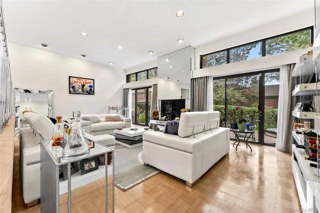a living room with furniture fireplace and large window
