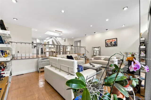 a living room with fireplace furniture and a potted plant
