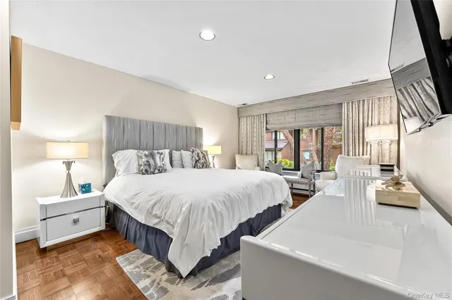 a bedroom with beds and a large window