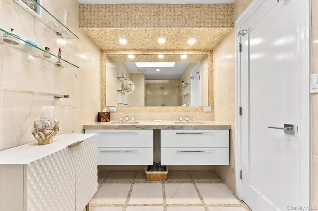 a spacious bathroom with a sink a mirror and a bathtub