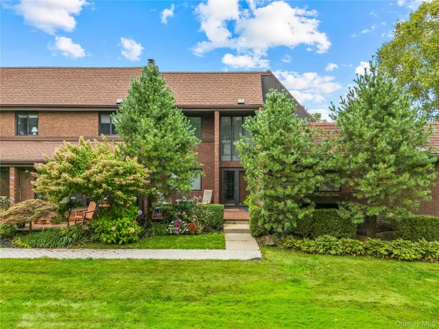 a view of a house with a yard and sitting area