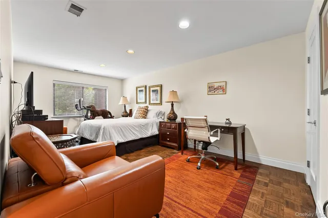 a living room with furniture a rug and a window