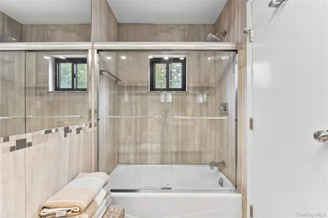 a bathroom with a bathtub and shower
