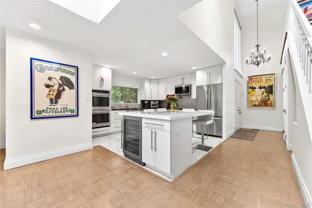 a kitchen with cabinets and wooden floor