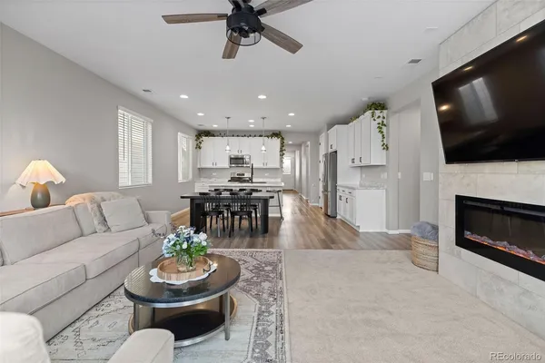 a living room with furniture a flat screen tv and a fireplace