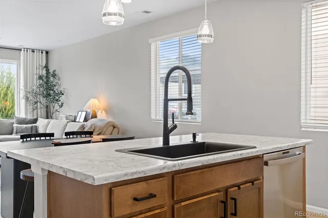 a kitchen with a sink a counter and a window