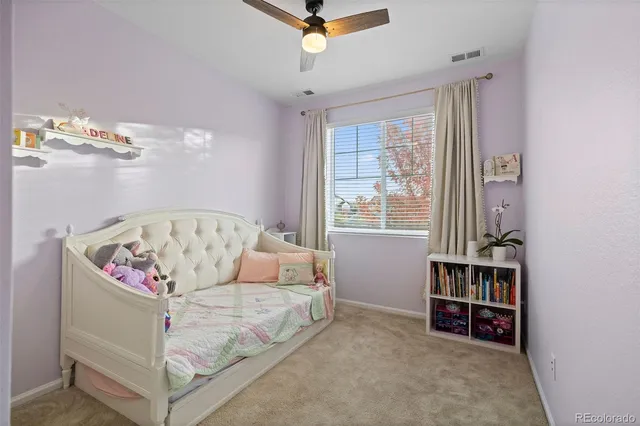 a living room with furniture and a book shelf